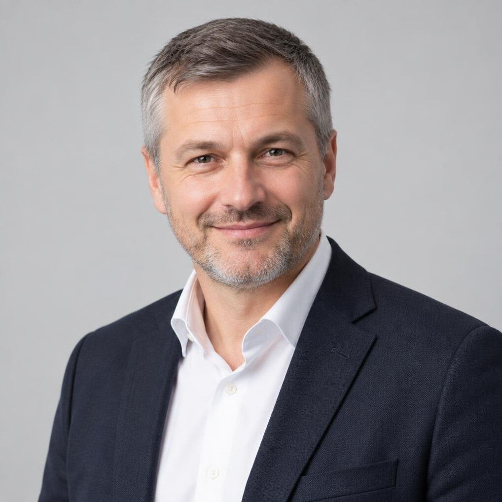 Czech man in his forties in business casual attire smiling confidently