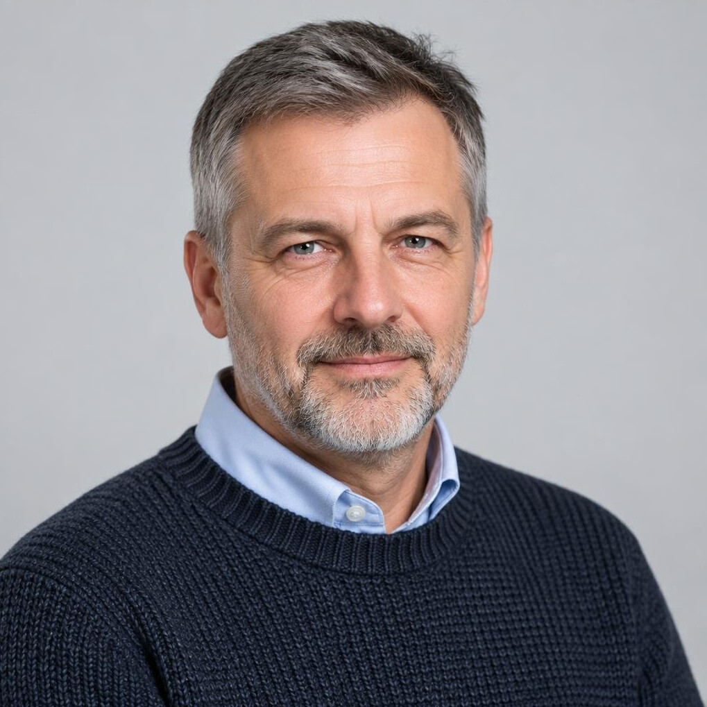 Czech man in his fifties with short beard wearing a sweater smiling